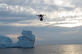 Hexacopter over the ocean, with an iceberg in the background